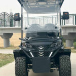 electric golf cart near campground cabins and a pathway pickup point